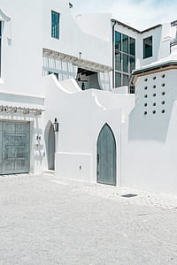 closed gray door of white painted 2-storey building thumbnail