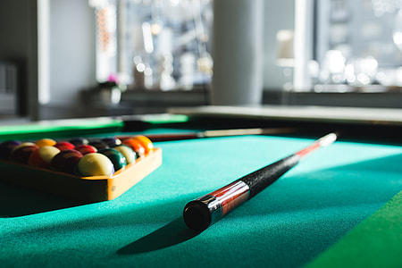 Billiard balls on green table with billiard cue thumbnail
