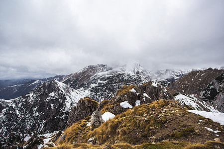 mountain covered with snow under white cloudy sky thumbnail