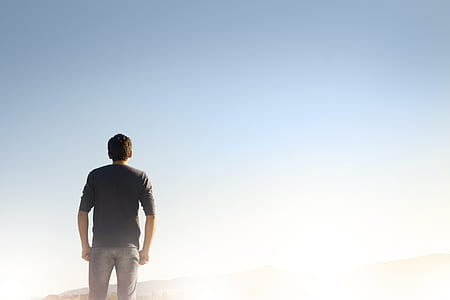man standing on brown soil under blue sky thumbnail