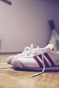 pair of white adidas sneakers on surface thumbnail