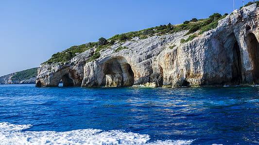 photo of mountain on body of water thumbnail