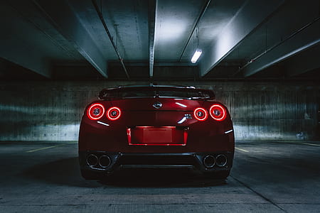 closeup photography of red Nissan GT-R R35 Nismo's rear inside garage thumbnail
