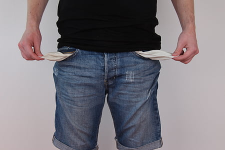 person wearing blue denim shorts showing empty pockets thumbnail