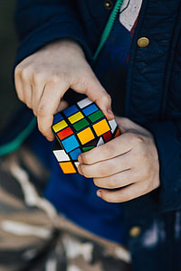 Boy in a blue jacket holding things thumbnail