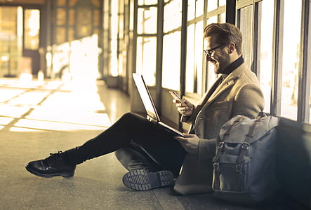 man sitting on floor while doing laptop thumbnail