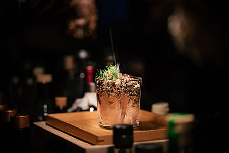 clear drinking glass on brown chopping board thumbnail