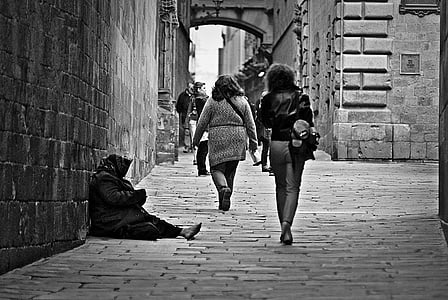 grayscale photo of people walking on concrete hallway thumbnail