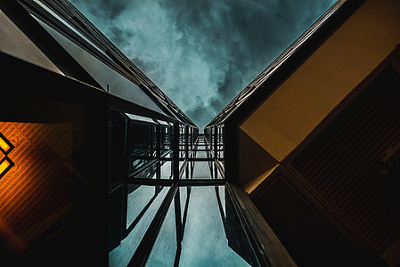 eye's worm view of high-rise building under dark sky thumbnail