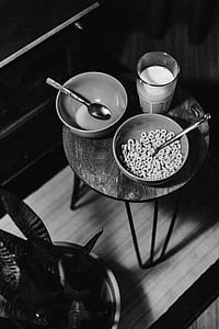 grayscale photography of cereals and milk on table thumbnail