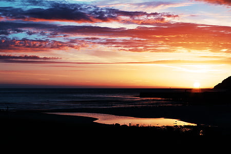 body of water during sunrise thumbnail