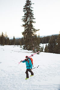 man walking on snow-covered mountain thumbnail