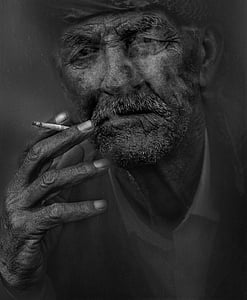 grayscale photo of man smoking thumbnail