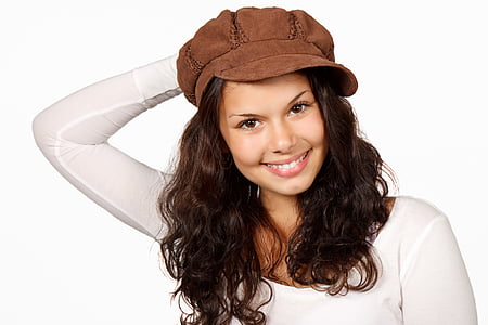 woman in white scoop-neck long-sleeved top and brown hat thumbnail