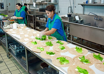 woman wearing green apron near sink thumbnail