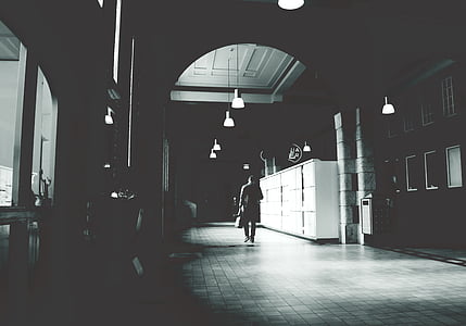 grey scale photography of man walking thumbnail