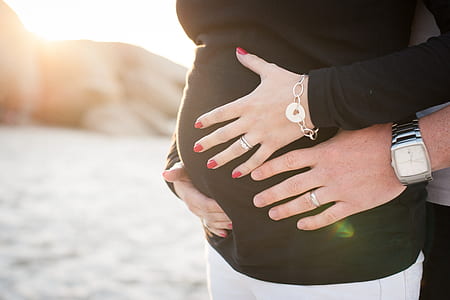 man holding his pregnant wife thumbnail