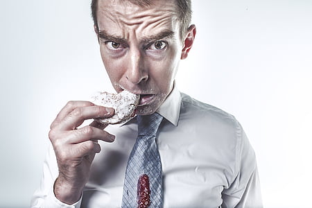 stock photography of man eating cookie thumbnail