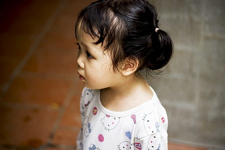 shallow focus photography of girl in white Hello Kitty print crew-neck shirt thumbnail
