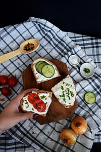 person holding cucomber and bread thumbnail