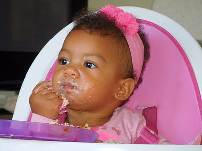 baby sitting on pink highchair thumbnail