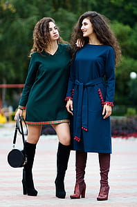 shallow focus photo of woman in blue long-sleeved dress thumbnail