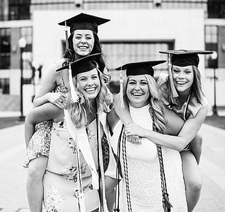 photo of four woman with academic hats thumbnail
