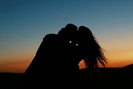 silhouette of couple kissing during golden hour thumbnail