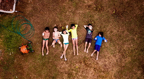 group of toddler lying down on brown ground thumbnail