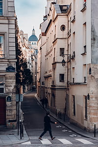 person walking in middle of buildings thumbnail