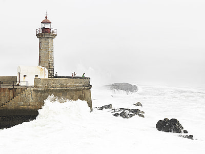 lighthouse beside body of water thumbnail