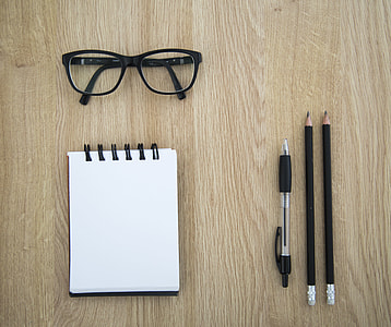 eyeglasses with black frames on table thumbnail