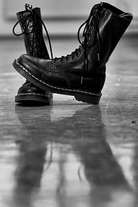 pair of black Doc Martens combat boots on gray surface thumbnail