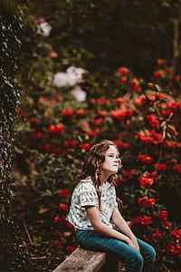 girl seating on brown fence thumbnail