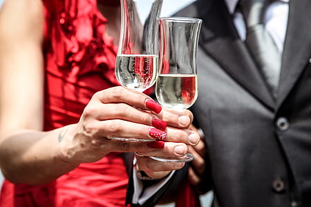 man and woman holding glass of champagne thumbnail
