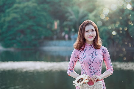 Woman Smiling While Standing Near Body of Water thumbnail