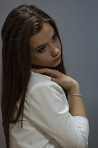 woman holding her shoulder inside room thumbnail