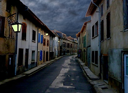 empty road between concrete houses thumbnail