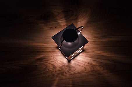 gray lantern on brown wooden surface thumbnail