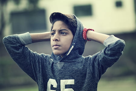 boy in gray hoodie holding his head thumbnail