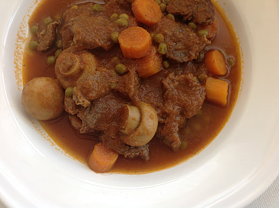 meat dish with mushrooms and carrots on white ceramic bowl thumbnail