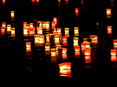 paper candle on body of water thumbnail