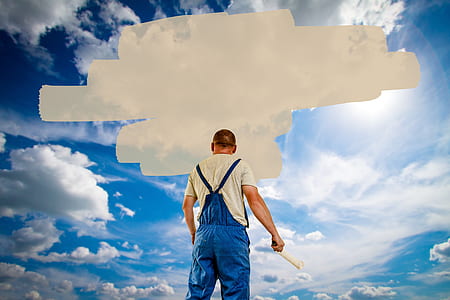 man holding pain roller with sky and clouds background thumbnail