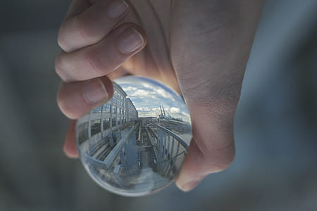 Person Holding Clear Glass Decor thumbnail