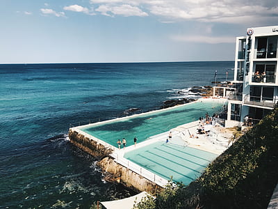 person standing near swimming pool thumbnail