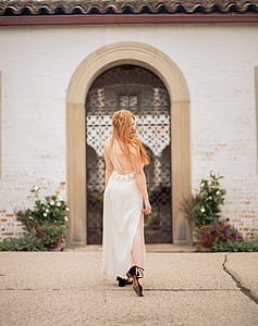 woman standing near white concrete building thumbnail