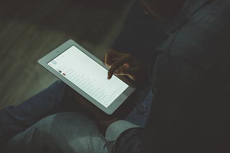 person holding and touching iPad thumbnail