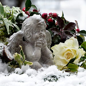 cherub figurine surrounded with flowers thumbnail