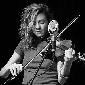grayscale photography of woman playing violin thumbnail