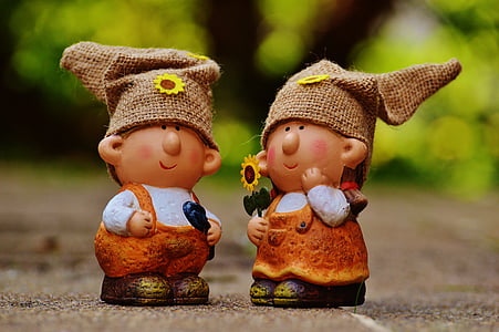 two girl and boy dwarf figurines on floor thumbnail